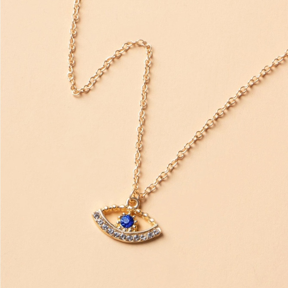 Unique Eye necklace with blue center Stone and rhinestone accented lash line